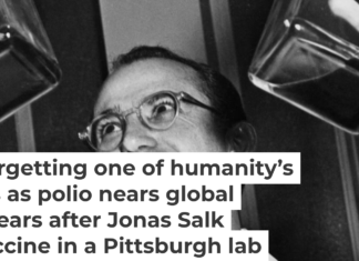 Dr. Jonas Salk displays his polio vaccine, which he developed in a University of Pittsburgh laboratory. Bettmann/Bettmann Collection via Getty Images